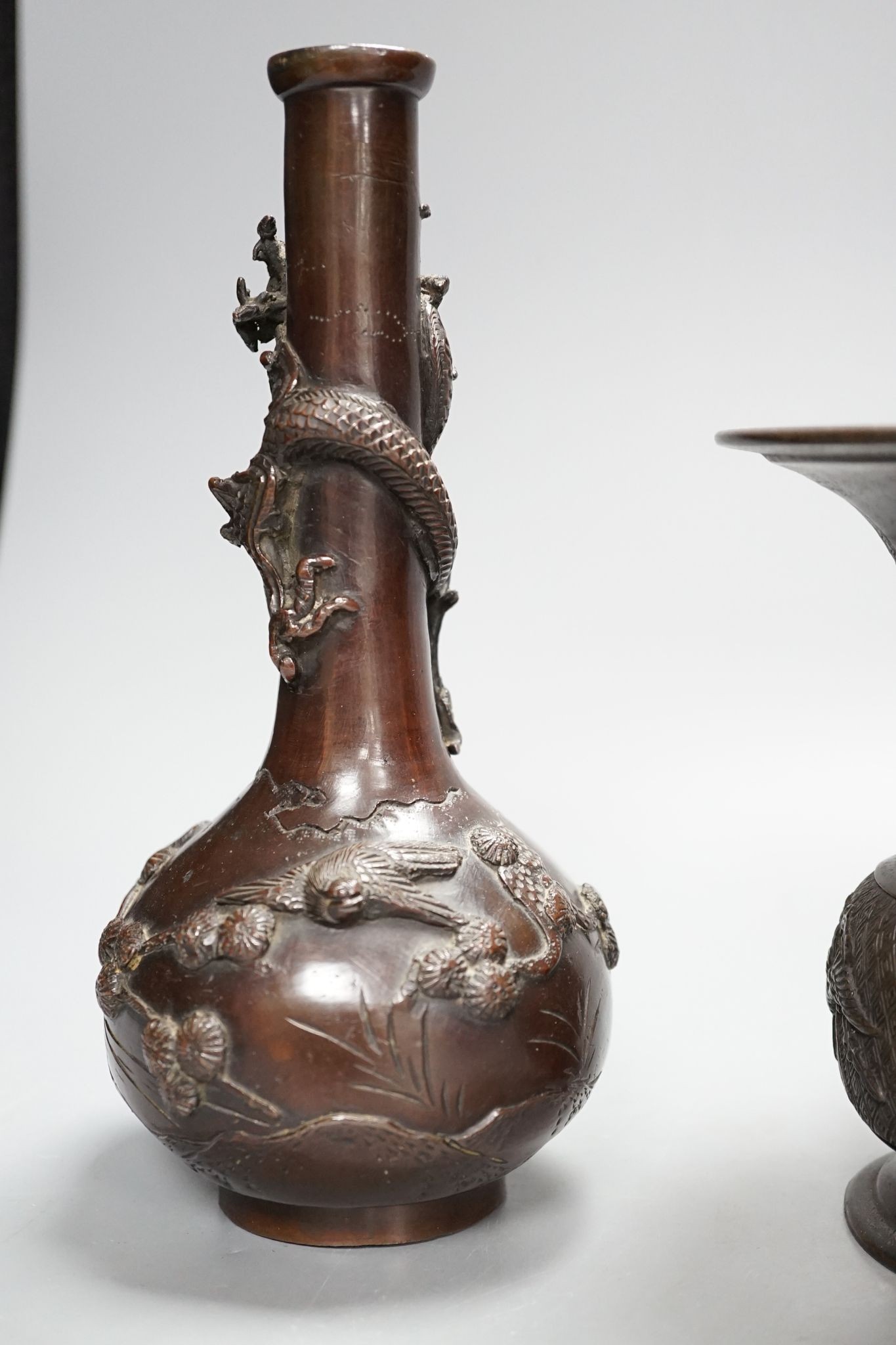 A pair of Japanese Meiji period bronze ‘dragon’ bottle vases and another, 21cm